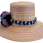 "Colorful handmade Wayuu hat from Iraca palm, adorned with cultural pompoms, adjustable for any head size, supports Wayuu chi
