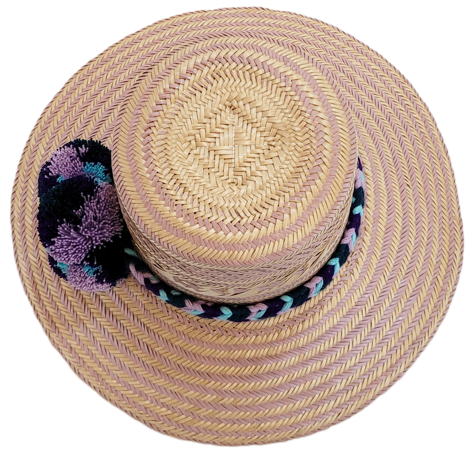 "Colorful handmade Wayuu hat from Iraca palm, adorned with cultural pompoms, adjustable for any head size, supports Wayuu chi