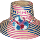 "Colorful handmade Wayuu hat from Iraca palm, adorned with significant pompoms, offering style and sun protection."