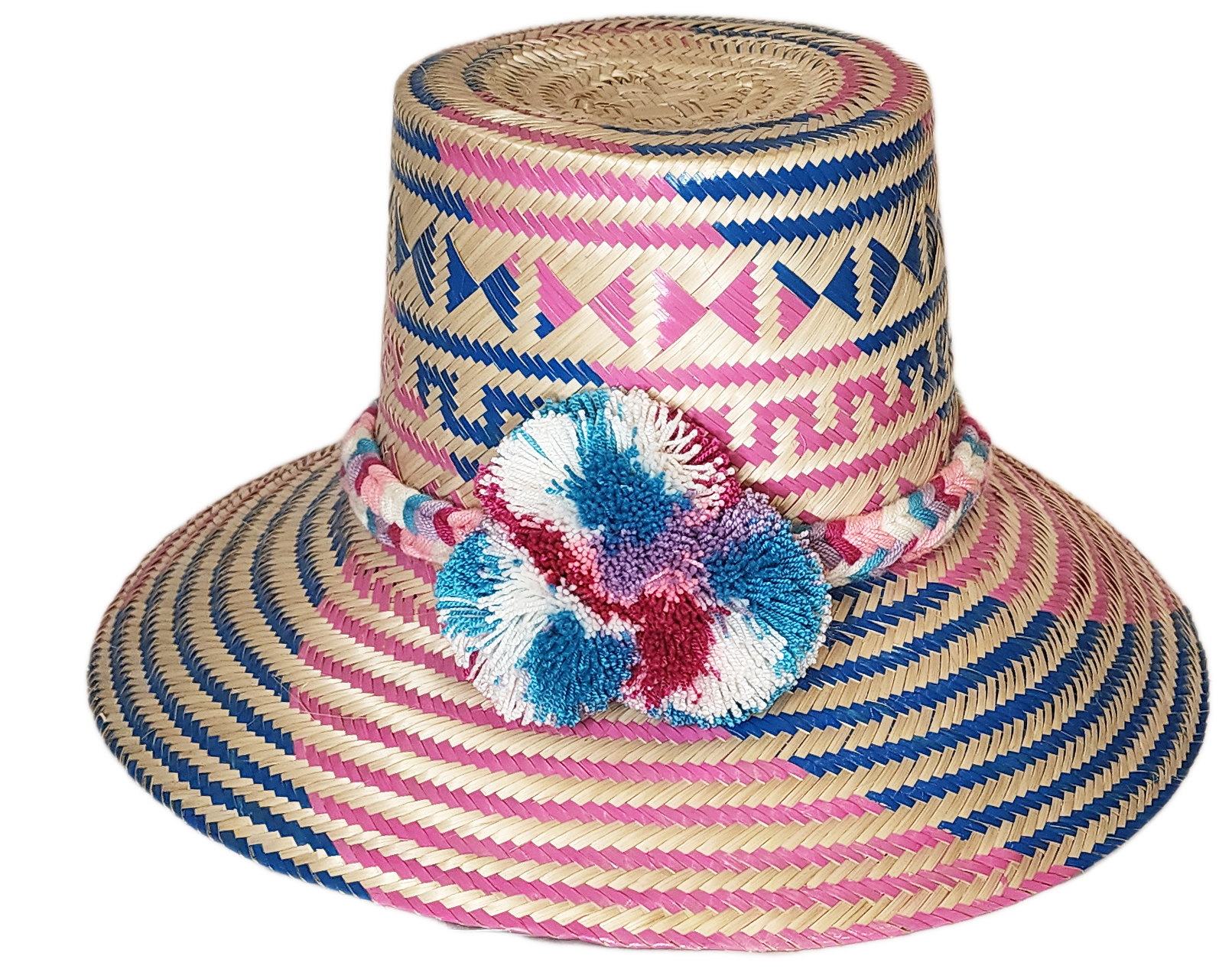 "Colorful handmade Wayuu hat from Iraca palm, adorned with significant pompoms, offering style and sun protection."