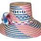 "Colorful handmade Wayuu hat from Iraca palm, adorned with significant pompoms, offering style and sun protection."