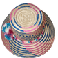 "Colorful handmade Wayuu hat from Iraca palm, adorned with significant pompoms, offering style and sun protection."