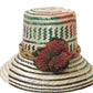 "Colorful handmade Wayuu hat from Iraca palm fiber, adorned with meaningful pompoms, showcasing vibrant, cultural design."