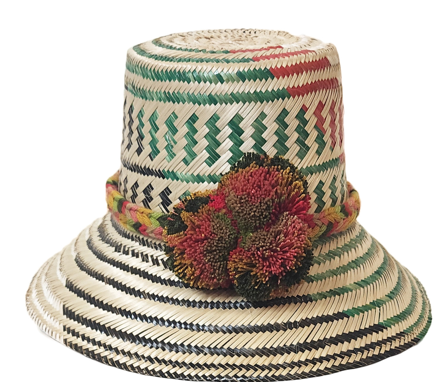 "Colorful handmade Wayuu hat from Iraca palm fiber, adorned with meaningful pompoms, showcasing vibrant, cultural design."
