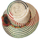 "Colorful handmade Wayuu hat from Iraca palm fiber, adorned with meaningful pompoms, showcasing vibrant, cultural design."