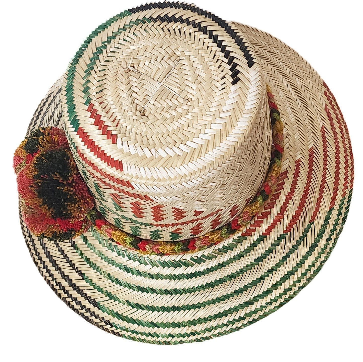 "Colorful handmade Wayuu hat from Iraca palm fiber, adorned with meaningful pompoms, showcasing vibrant, cultural design."