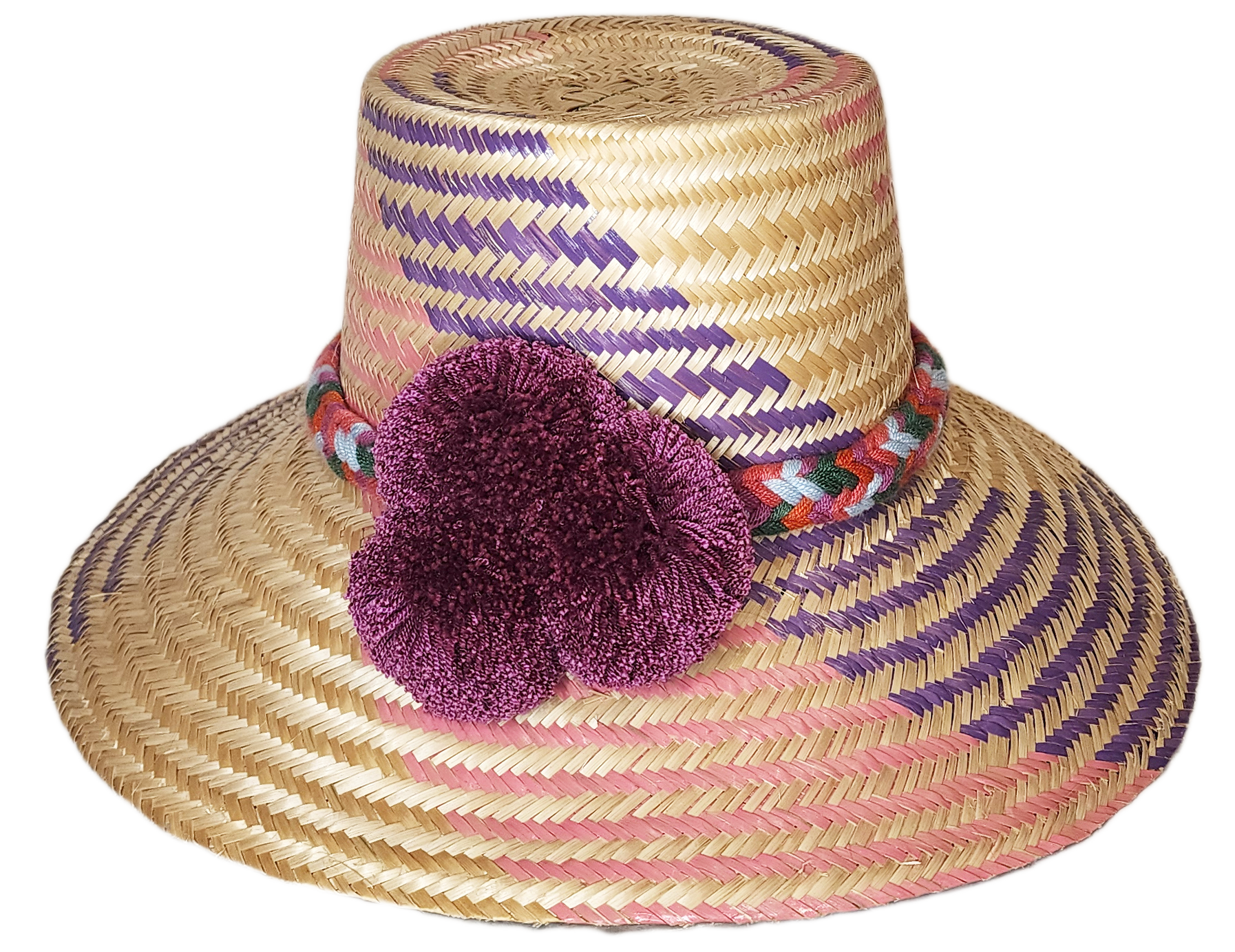 "Colorful handmade Wayuu hat from Iraca palm fibers, adorned with symbolic pompoms, offering sun protection and adjustable fi