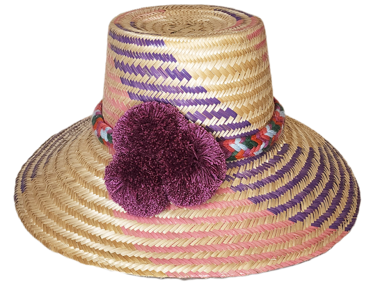 "Colorful handmade Wayuu hat from Iraca palm fibers, adorned with symbolic pompoms, offering sun protection and adjustable fi