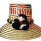 "Colorful Handmade Wayuu Hat from Iraca palm fibers, adorned with culturally significant pompoms, crafted by Wuitusu artisans