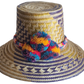 "Colorful handmade Wayuu hat from Iraca palm fibers, adorned with culturally significant pompoms, showcasing unique artisan c
