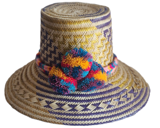 "Colorful handmade Wayuu hat from Iraca palm fibers, adorned with culturally significant pompoms, showcasing unique artisan c