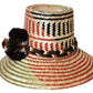"Colorful Handmade Wayuu Hat from Iraca palm fibers, adorned with culturally significant pompoms, crafted by Wuitusu artisans