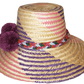 "Colorful handmade Wayuu hat from Iraca palm fibers, adorned with symbolic pompoms, offering sun protection and adjustable fi
