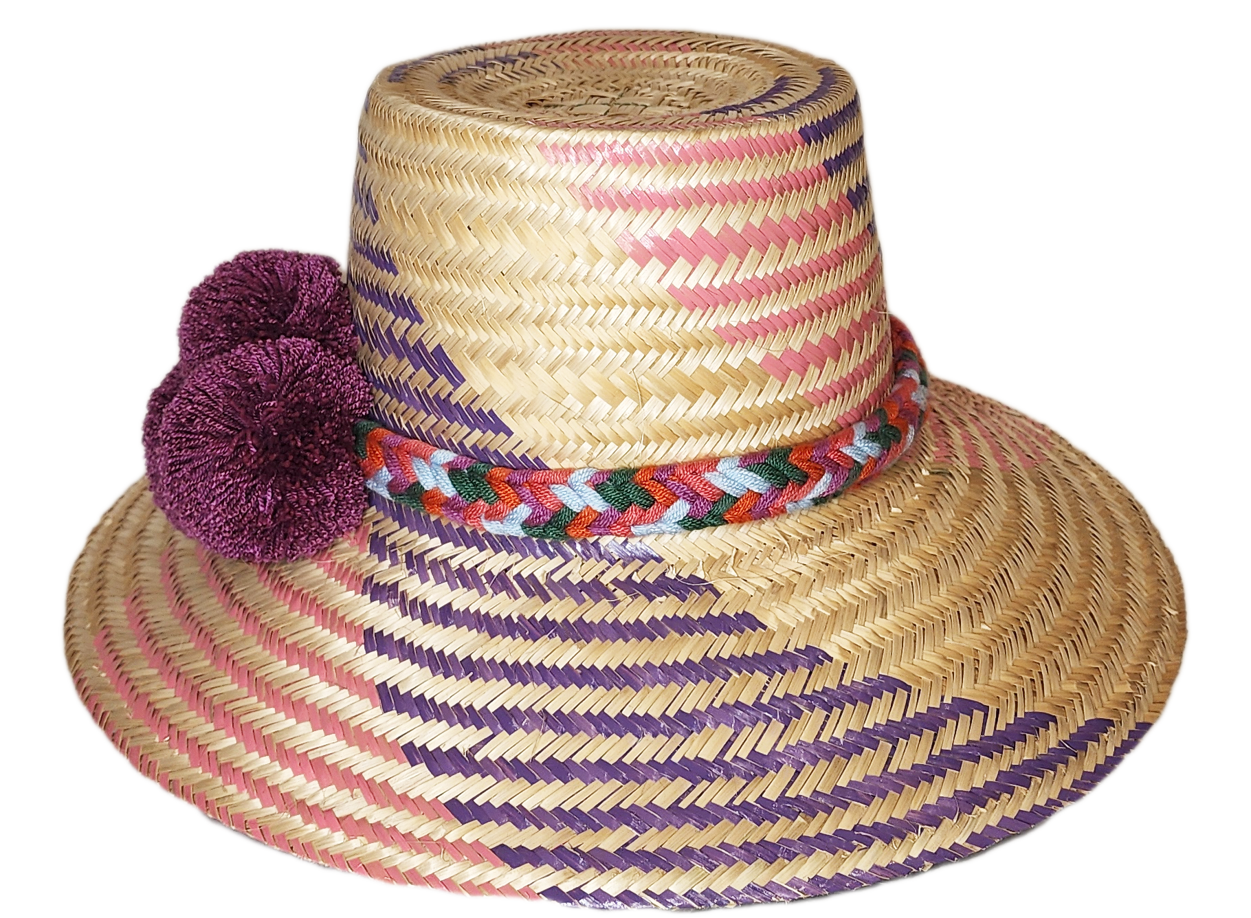 "Colorful handmade Wayuu hat from Iraca palm fibers, adorned with symbolic pompoms, offering sun protection and adjustable fi