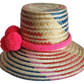 "Colorful handmade Wayuu hat from Iraca palm fibers, adorned with culturally significant pompoms, showcasing unique weaving b