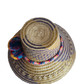 "Colorful handmade Wayuu hat from Iraca palm fibers, adorned with culturally significant pompoms, showcasing unique artisan c