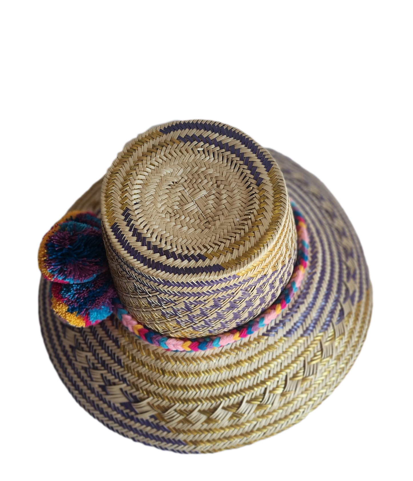 "Colorful handmade Wayuu hat from Iraca palm fibers, adorned with culturally significant pompoms, showcasing unique artisan c