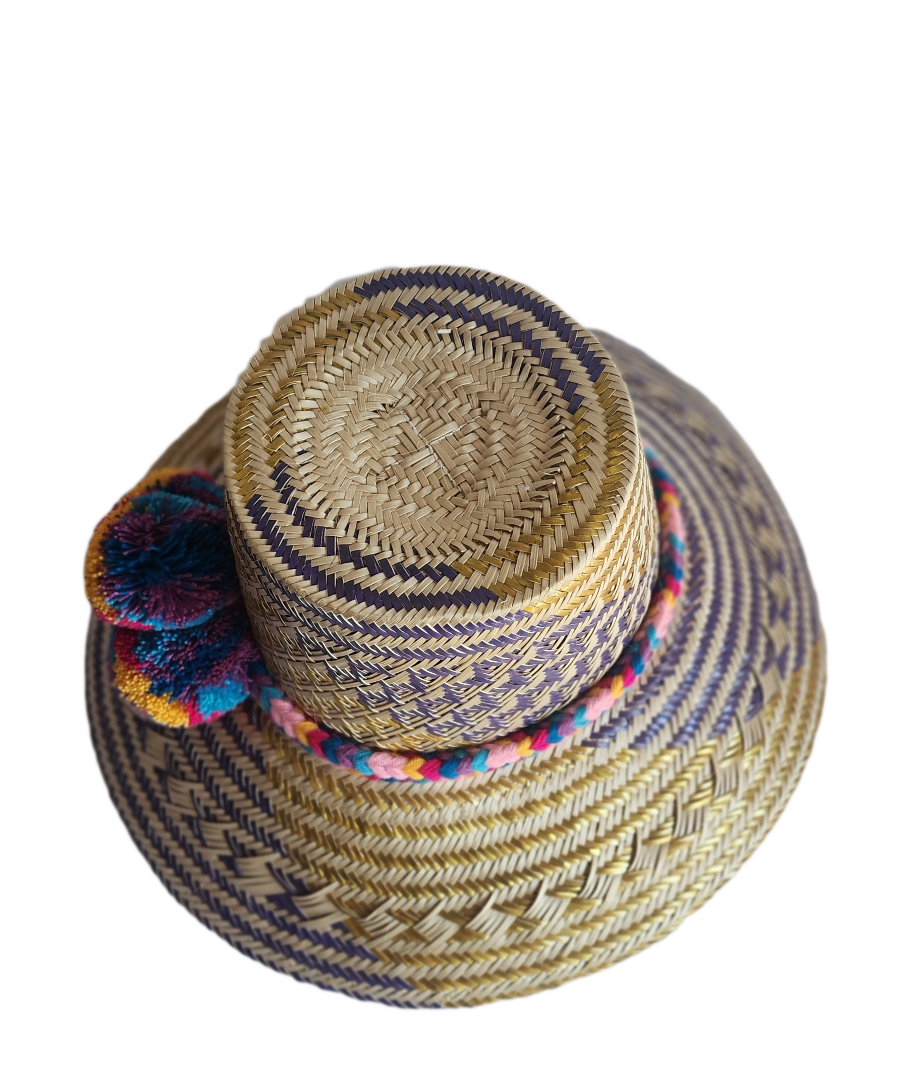 "Colorful handmade Wayuu hat from Iraca palm fibers, adorned with culturally significant pompoms, showcasing unique artisan c