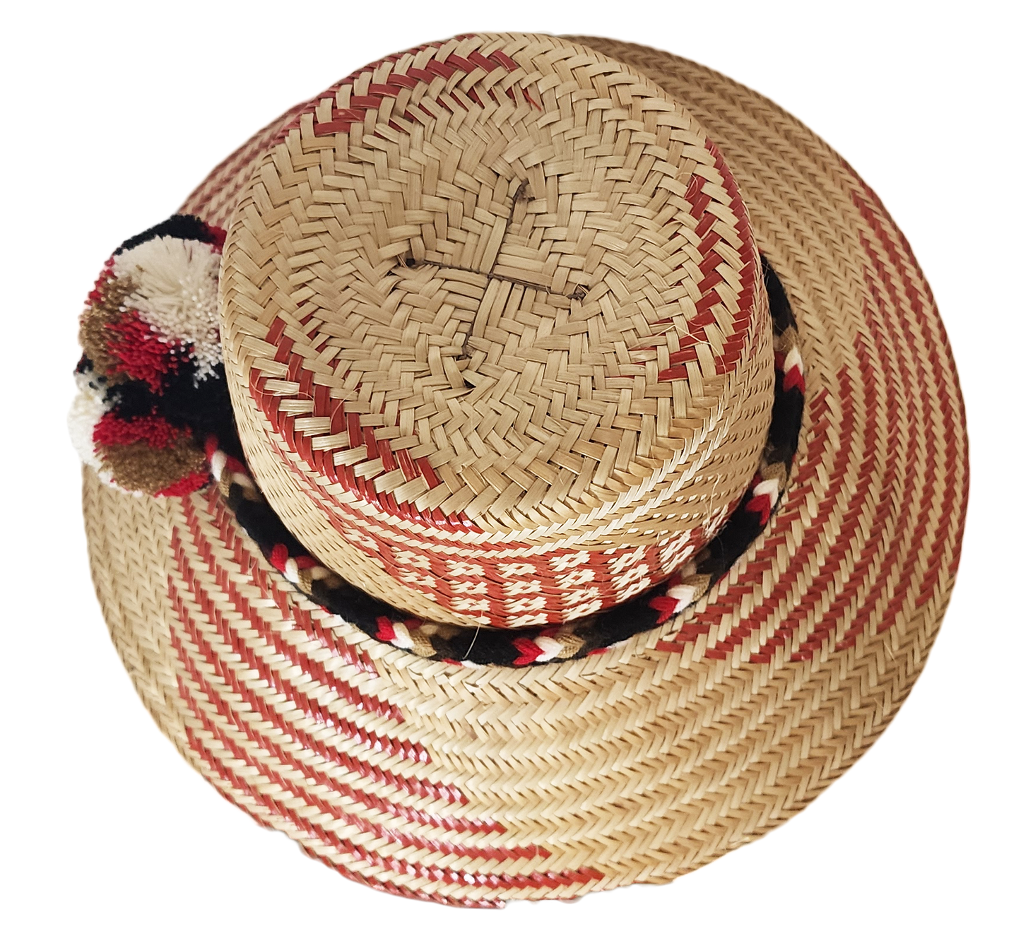 "Colorful handmade Wayuu hat from Iraca palm fibers, featuring adjustable fit and cultural pompoms, supporting Wayuu Taya Fou