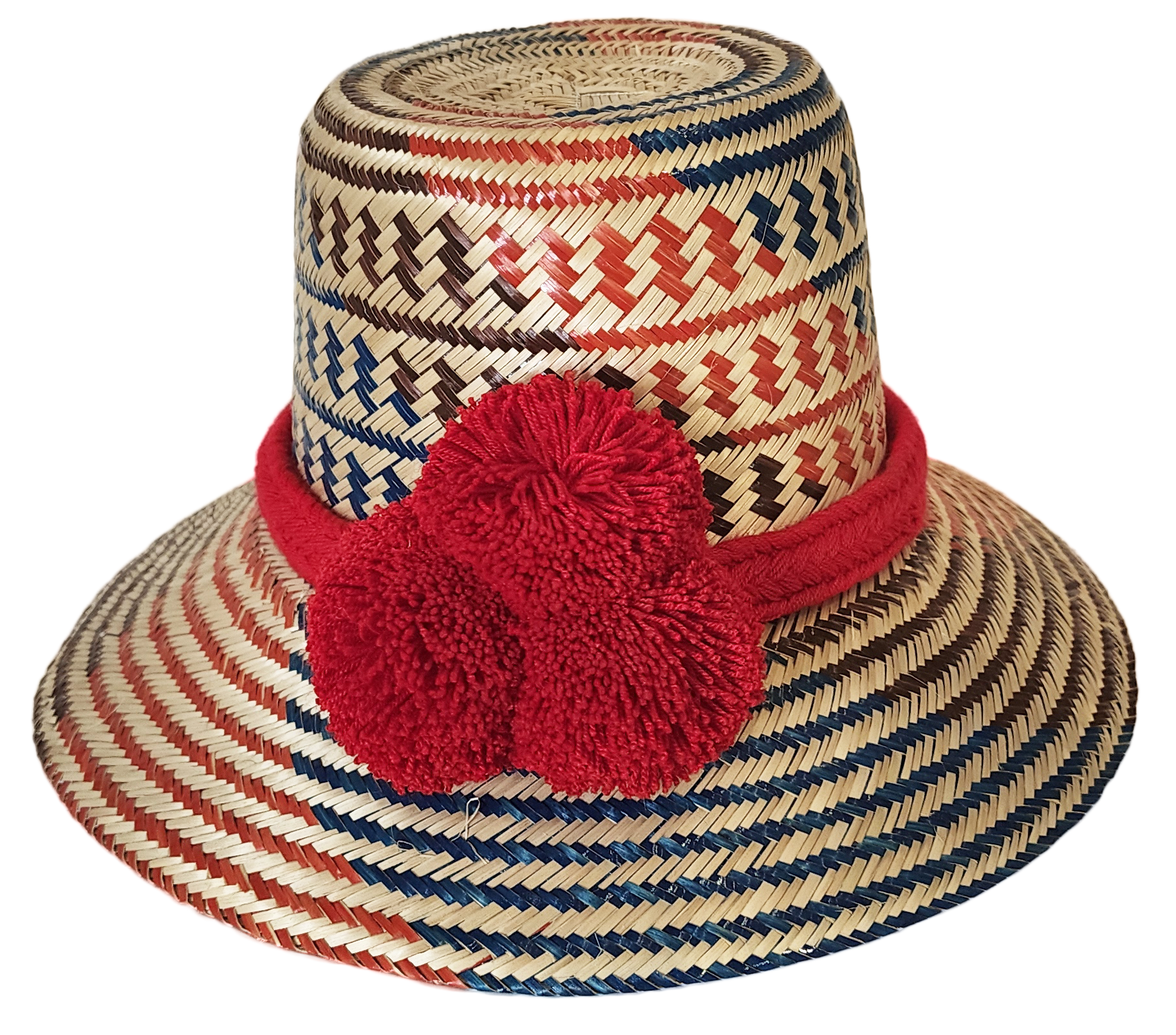 "Colorful handmade Wayuu hat from Wuitusu, crafted with Iraca palm fibers, adorned with culturally significant pompoms."