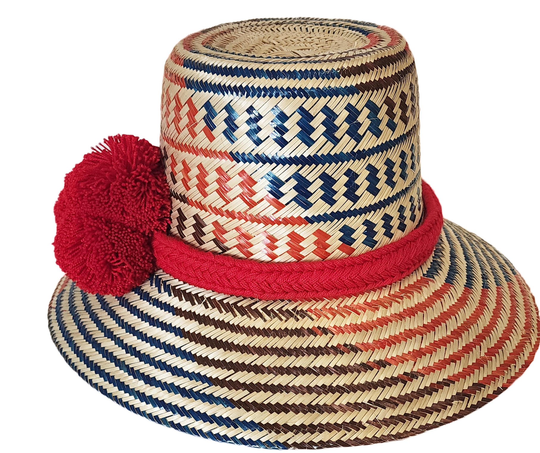 "Colorful handmade Wayuu hat from Wuitusu, crafted with Iraca palm fibers, adorned with culturally significant pompoms."