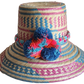 "Colorful handmade Wayuu hat, handwoven from Iraca palm fibers, adorned with culturally significant pompoms, adjustable fit."