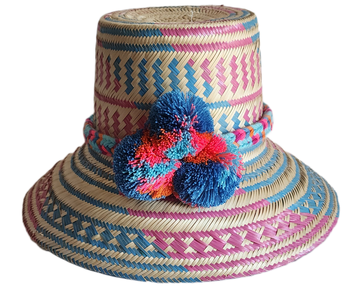 "Colorful handmade Wayuu hat, handwoven from Iraca palm fibers, adorned with culturally significant pompoms, adjustable fit."
