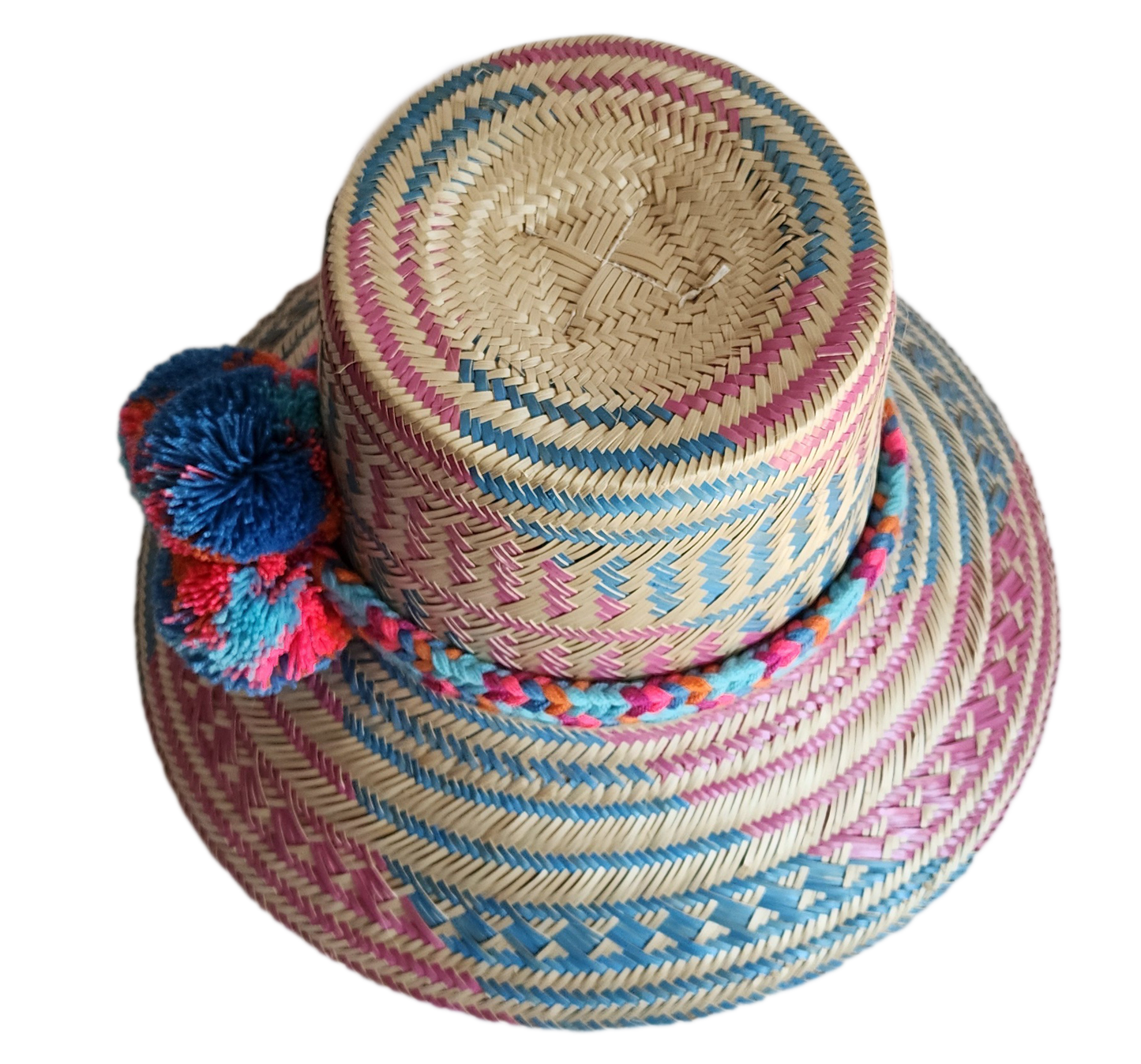 "Colorful handmade Wayuu hat, handwoven from Iraca palm fibers, adorned with culturally significant pompoms, adjustable fit."