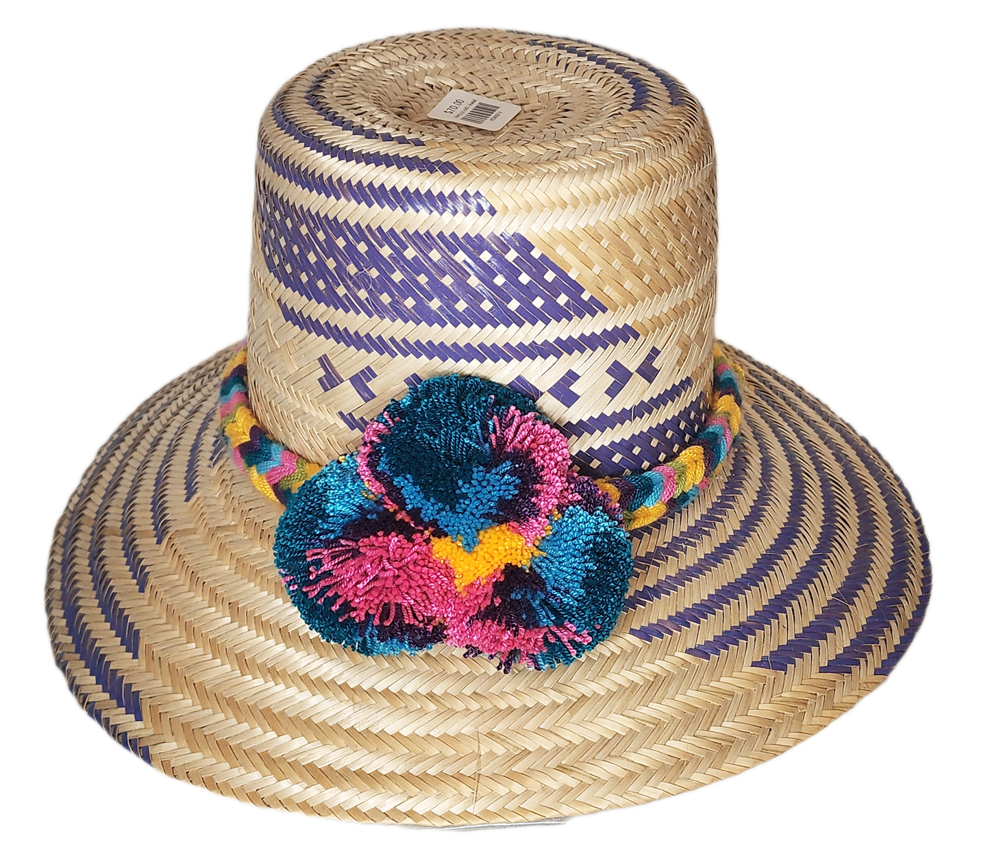 "Colorful handmade Wayuu hat with decorative pompoms, crafted from Iraca palm fibers by Wuitusu artisans."