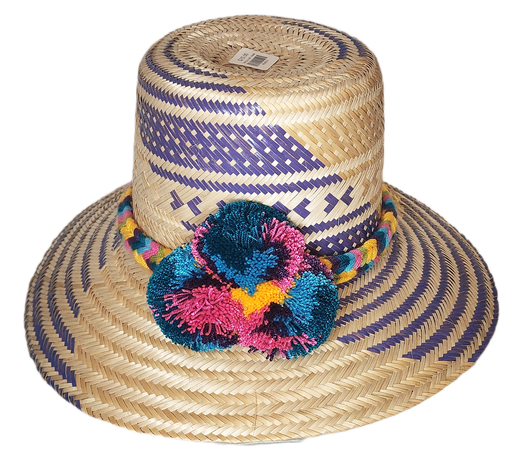 "Colorful handmade Wayuu hat with decorative pompoms, crafted from Iraca palm fibers by Wuitusu artisans."
