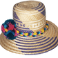 "Colorful handmade Wayuu hat with decorative pompoms, crafted from Iraca palm fibers by Wuitusu artisans."