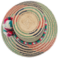 "Colorful handmade Wayuu hat with decorative pompoms, crafted from Iraca palm fibers, offering style and sun protection."