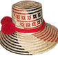 "Colorful handmade Wayuu hat with vibrant pompoms, crafted from Iraca palm fibers by the Wayuu tribe, adjustable for various 