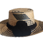 "Colorful handmade Wayuu hat woven from Iraca palm fibers, adjustable fit, adorned with culturally significant pompoms."