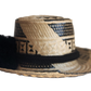 "Colorful handmade Wayuu hat woven from Iraca palm fibers, adjustable fit, adorned with culturally significant pompoms."