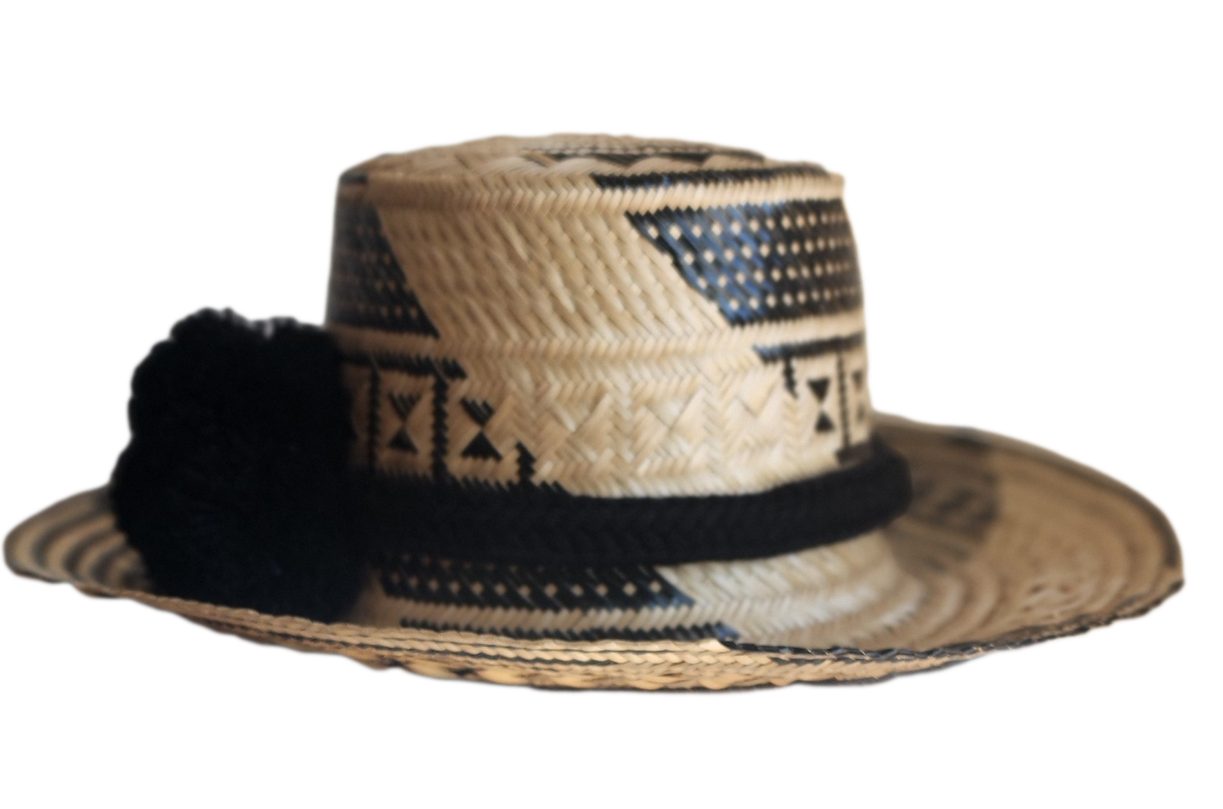 "Colorful handmade Wayuu hat woven from Iraca palm fibers, adjustable fit, adorned with culturally significant pompoms."