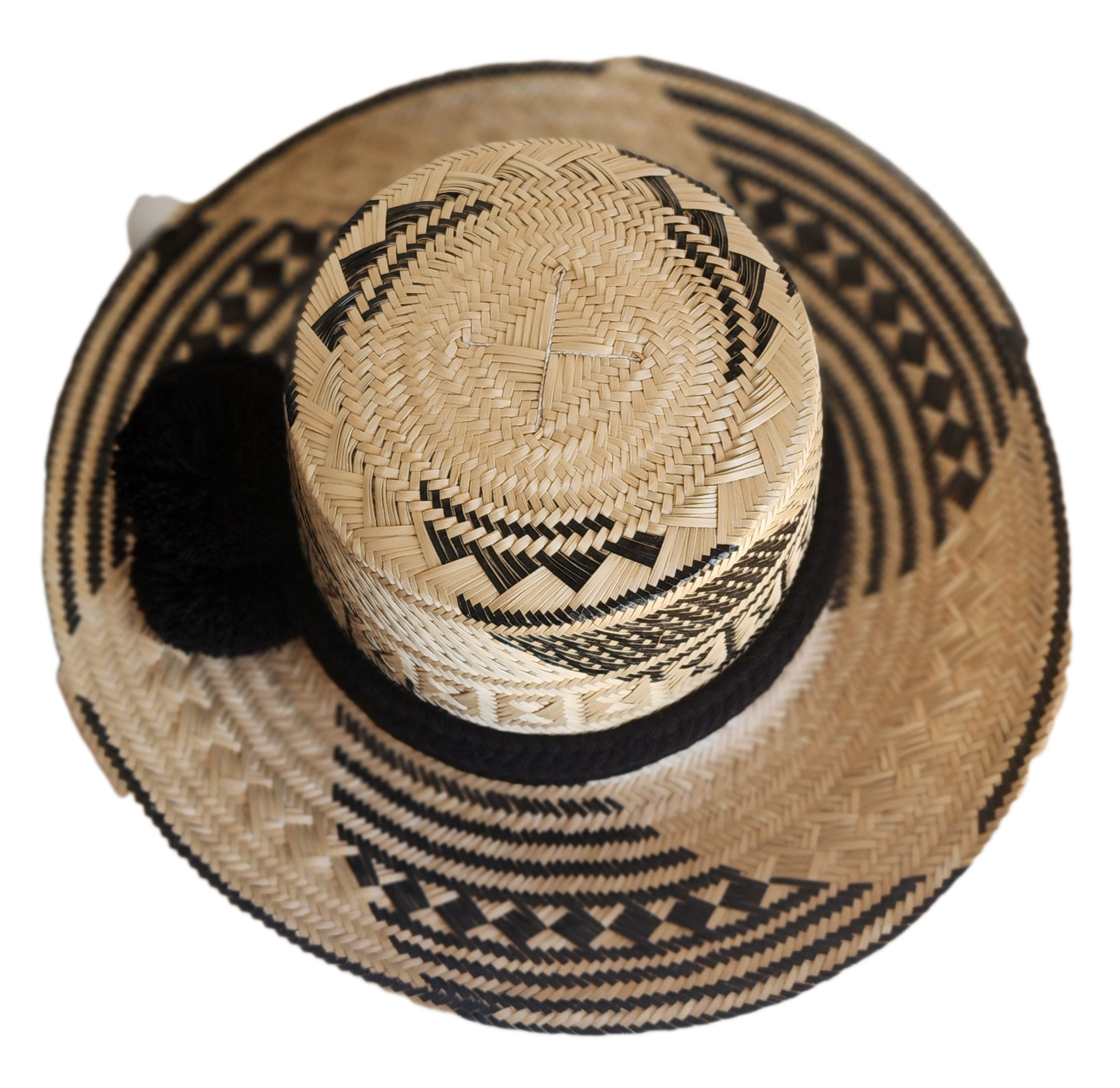 "Colorful handmade Wayuu hat woven from Iraca palm fibers, adjustable fit, adorned with culturally significant pompoms."