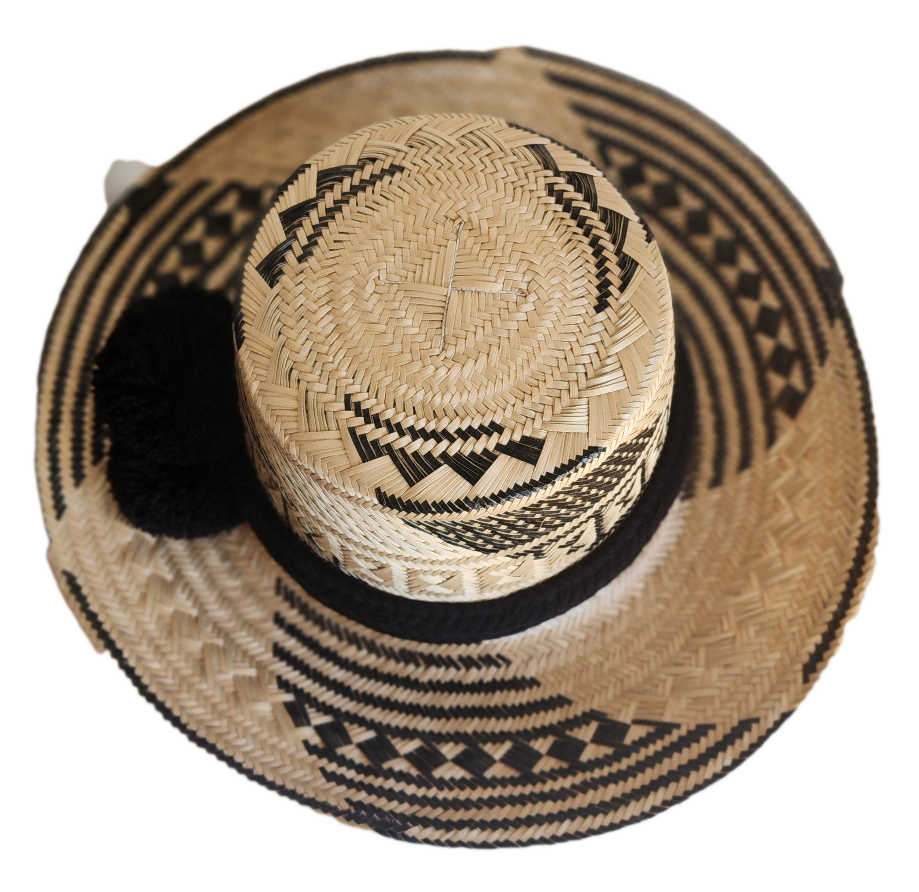 "Colorful handmade Wayuu hat woven from Iraca palm fibers, adjustable fit, adorned with culturally significant pompoms."