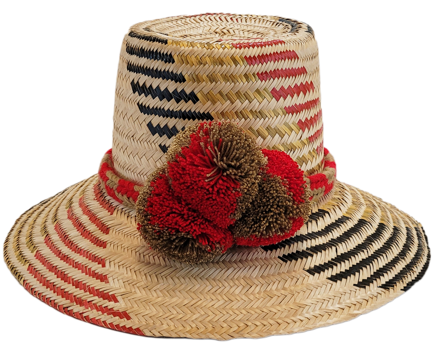 "Colorful handmade Wayuu hat crafted from Iraca palm fibers, adorned with significant cultural pom-poms for style and sun pro