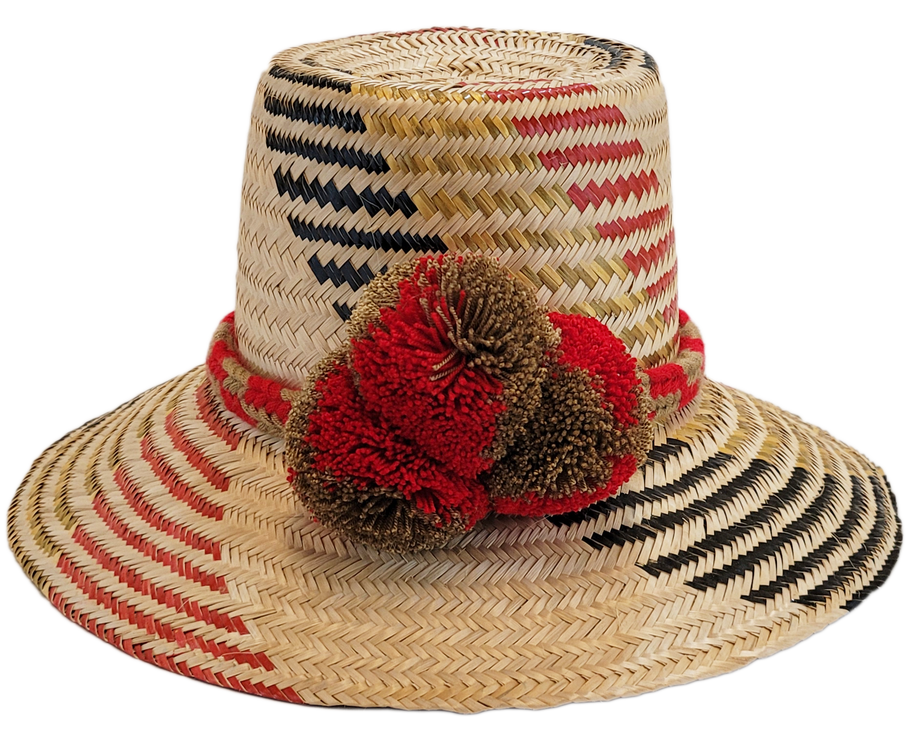 "Colorful handmade Wayuu hat crafted from Iraca palm fibers, adorned with significant cultural pom-poms for style and sun pro