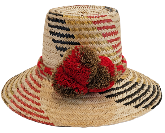 "Colorful handmade Wayuu hat crafted from Iraca palm fibers, adorned with significant cultural pom-poms for style and sun pro