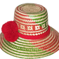 "Colorful handmade Wayuu hat woven from Iraca palm fibers, adorned with significant pompoms, adjustable for style and fit."