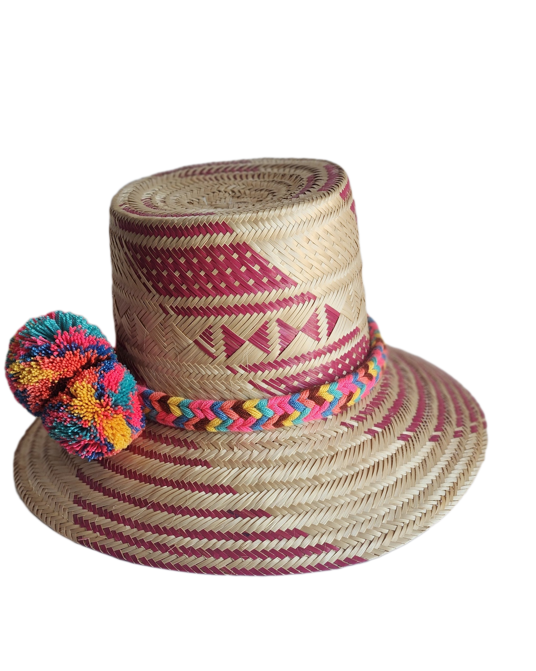 "Colorful handmade Wayuu hat woven from Iraca palm fibers, adorned with culturally significant pompoms, offering adjustable f