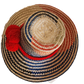 "Colorful handmade Wayuu hat woven from Iraca palm fibers, adorned with significant pompoms, adjustable for various sizes."