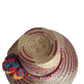 "Colorful handmade Wayuu hat woven from Iraca palm fibers, adorned with culturally significant pompoms, offering adjustable f