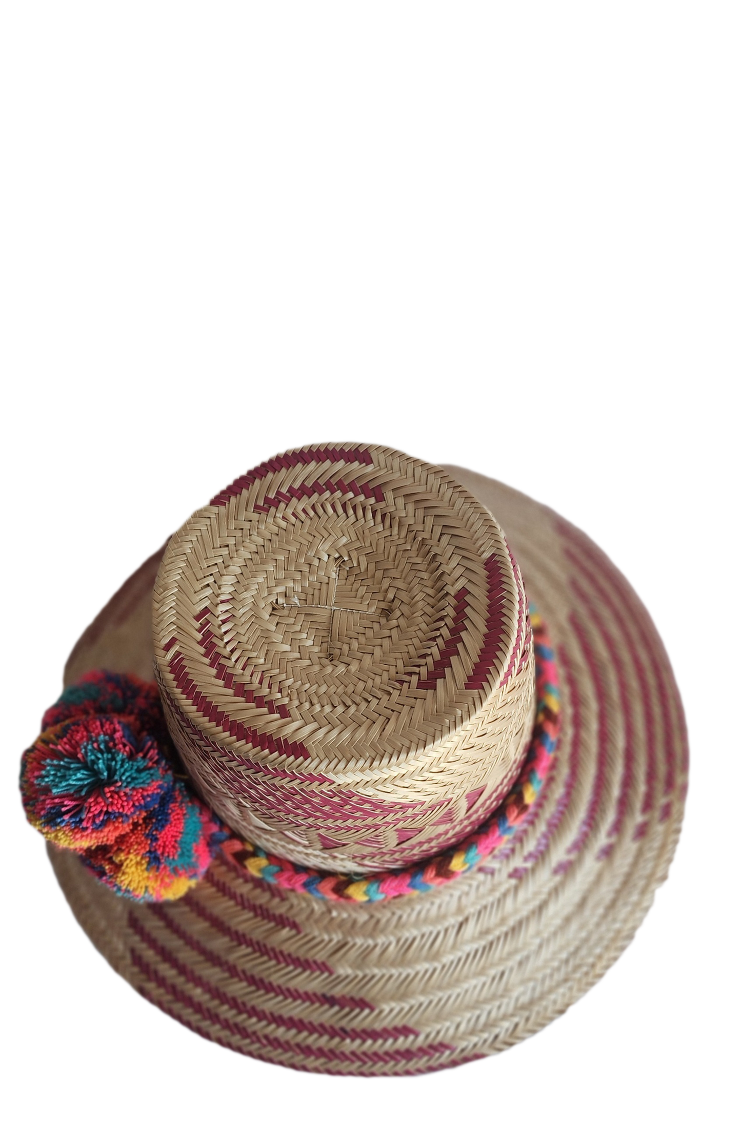 "Colorful handmade Wayuu hat woven from Iraca palm fibers, adorned with culturally significant pompoms, offering adjustable f