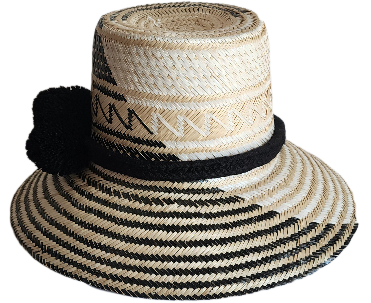 "Colorful handmade Wayuu hat woven from Iraca palm fibers, featuring adjustable fit and culturally significant pompoms."