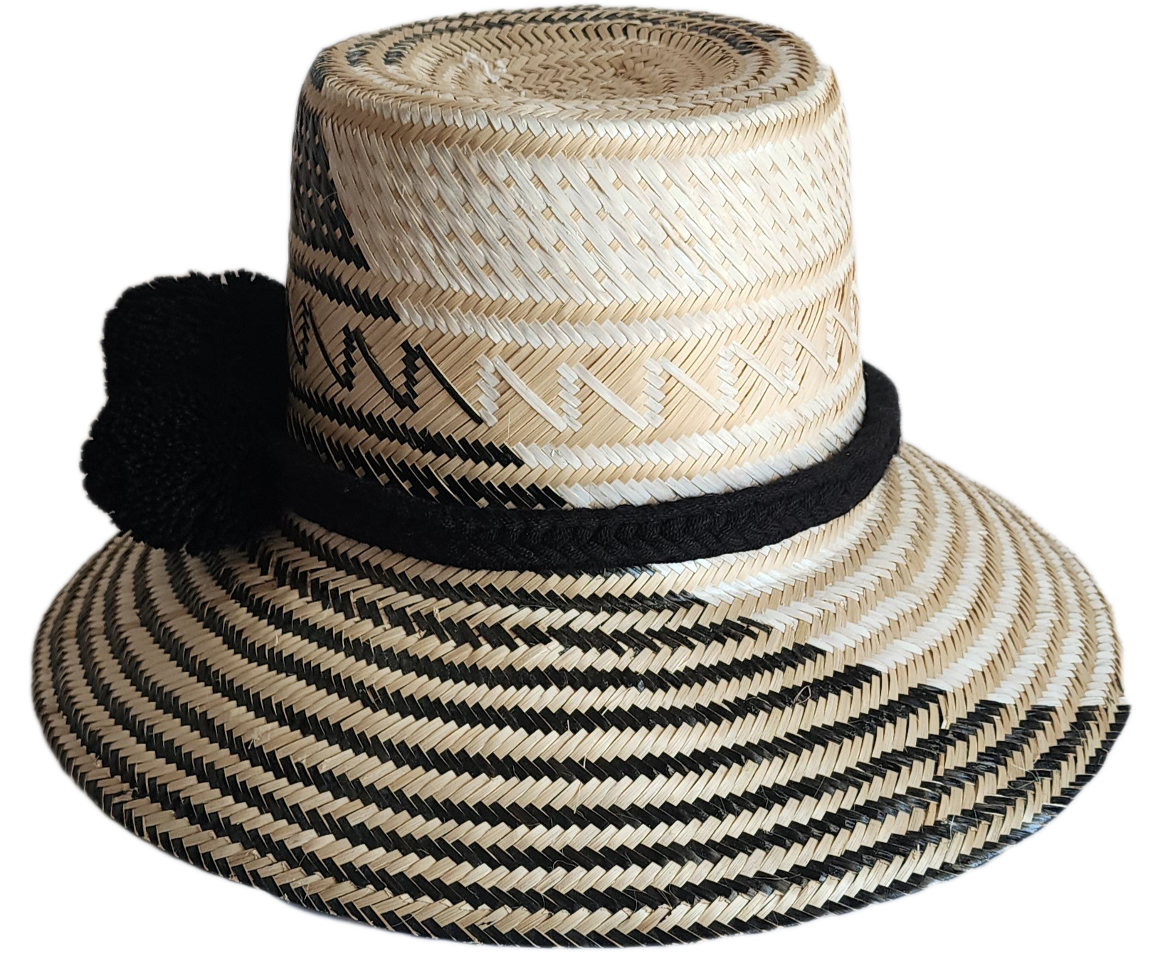 "Colorful handmade Wayuu hat woven from Iraca palm fibers, featuring adjustable fit and culturally significant pompoms."