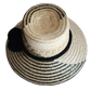 "Colorful handmade Wayuu hat woven from Iraca palm fibers, featuring adjustable fit and culturally significant pompoms."