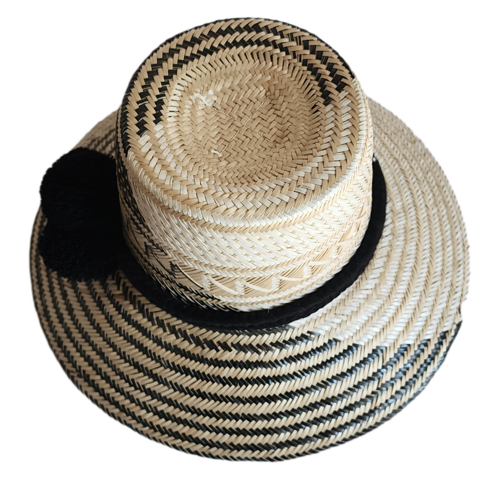 "Colorful handmade Wayuu hat woven from Iraca palm fibers, featuring adjustable fit and culturally significant pompoms."